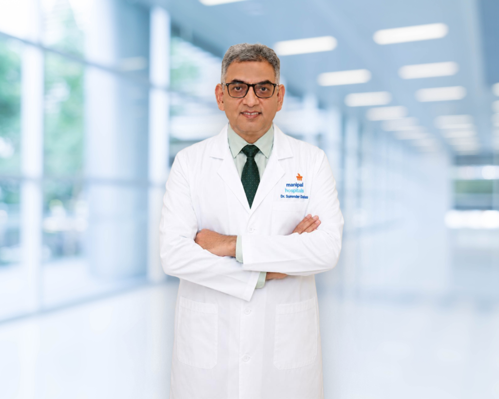 Dr. Surender Kumar Dabas consulting with a patient